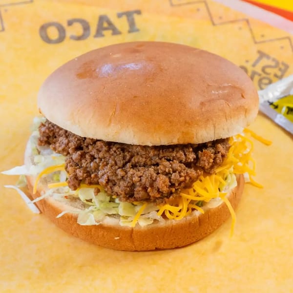 A Sloppy Joe sandwich with ground beef, shredded lettuce, and cheese on a bun.